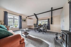 a living room with a couch and a table at Ivy Cottage in Buckland in the Moor