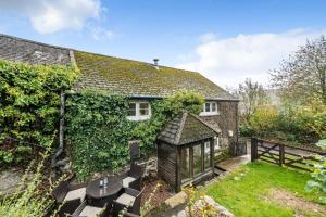 an exterior view of a house with a garden at Ivy Cottage in Buckland in the Moor