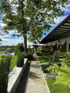 a garden with a tree and a sidewalk at Baum Hotel in Armenia