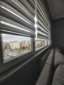 a room with a window with blinds and a couch at Şirinevler meydan daire in Istanbul
