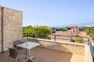 a balcony with a table and chairs and a view at Villa Sa Llimonera by Slow Villas in Es Llombards