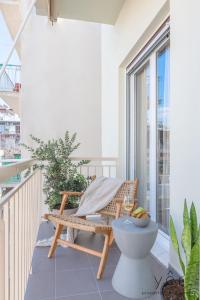 a balcony with a chair and a toilet at Boho-Romance Oasis / Love & Luxury Hot Tub in Athens