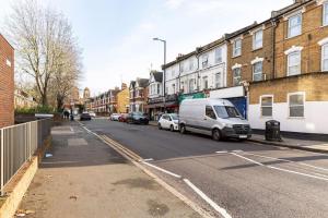 a street with a van parked on the side of the road at Parkside Stay North London - Victoria Line in London