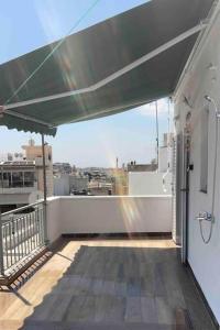 an outdoor balcony with a view of a city at Rooftop Acropolis Apartment Athens in Athens