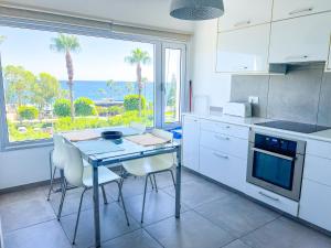a kitchen with a table and a view of the ocean at Panoramic Sea View Apt - 2bed in Limassol