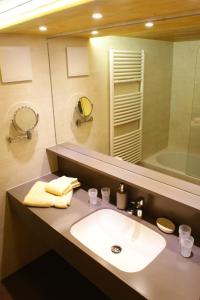 a bathroom with a sink and a large mirror at Haus Gstüat in Lech am Arlberg