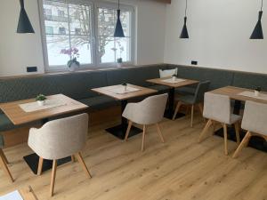 a row of tables and chairs in a restaurant at Frühstückspension Erika in Schladming