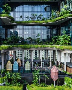 an office building with a green roof with plants at PARKROYAL COLLECTION Pickering, Singapore in Singapore