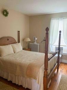 a bedroom with a bed and a window at Elegant 2BR Apt w 2 Bathrooms in Historic Hamlet by Berkshires & Hudson Valley, Walk to Restaurants in Hillsdale