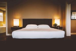 a bedroom with a large white bed with two lamps at Palacio Duhau - Park Hyatt Buenos Aires in Buenos Aires