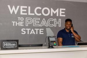 a man talking on a cell phone at a desk at Hampton Inn Atlanta-Georgia Tech-Downtown in Atlanta