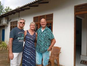 a group of people standing in front of a house at Serene Homestay in Anuradhapura