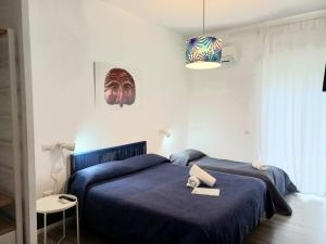 Posteľ alebo postele v izbe v ubytovaní Nonna Pina Art Rooms