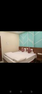 a bedroom with a bed with two pillows on it at HoTE 56 indore in Indore
