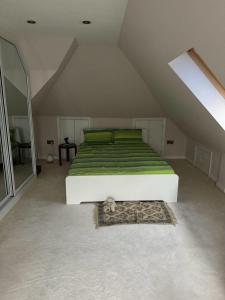 a bedroom with a bed with a cat laying on a rug at Cosy and lovely 4-Bed House in Stanmore in Stanmore