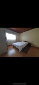 a bedroom with a bed in a room with a window at Elgon View House in Eldoret