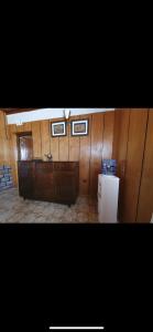 a room with wood paneled walls and a refrigerator at Elgon View House in Eldoret