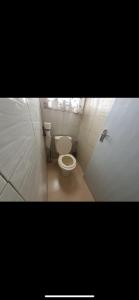 a small bathroom with a toilet in a stall at Elgon View House in Eldoret