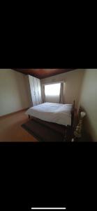 a bedroom with a bed and a window at Elgon View House in Eldoret
