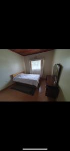 a small bedroom with a bed and a window at Elgon View House in Eldoret