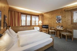 Postel nebo postele na pokoji v ubytování Hotel Restaurant Bänklialp