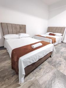 Voodi või voodid majutusasutuse Hotel Maranta toas