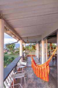 a hammock on the porch of a house at Hotel Maranta in Pereira