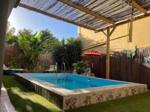 a swimming pool in a backyard with a wooden fence at Casa Con Piscina en el Centro in Los Llanos de Aridane