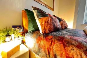 a bedroom with a bed with a comforter and pillows at Remarkable 1-Bed Apartment in Dundee in Dundee