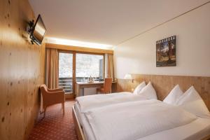 Postel nebo postele na pokoji v ubytování Hotel Restaurant Bänklialp