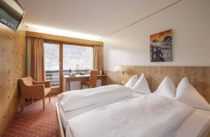 Postel nebo postele na pokoji v ubytování Hotel Restaurant Bänklialp