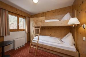 Postel nebo postele na pokoji v ubytování Hotel Restaurant Bänklialp