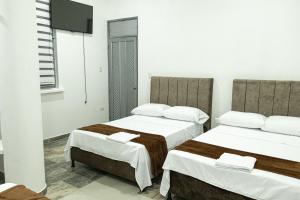 Voodi või voodid majutusasutuse Hotel Maranta toas