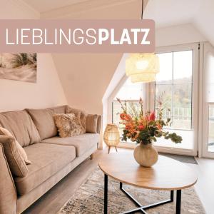 a living room with a couch and a table at Lieblingsplatz.. wunderschön an der Ostsee, mit Blick auf die Förde in Harrislee