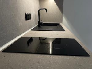 a kitchen with a sink in a counter at Nikitas loft in Kalamata