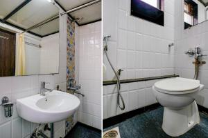 a bathroom with a toilet and a sink at FabHotel King's Palace in Mumbai