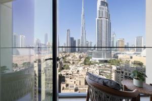 a room with a view of a city from a window at Stunning Burj Royale Residence Downtown Dubai - Burj Khalifa in Dubai