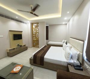 a bedroom with a bed and a television in a room at Hotel Annpurna Regency in Sīkar