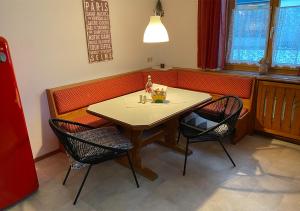 a dining room with a table and two chairs at Jägers Wohnung zwischen Ehrenberg und Neuschwanstein in Reutte