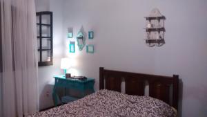 a bedroom with a bed and a table with a lamp at Chácara Sensorial Nova Friburgo RJ in Nova Friburgo