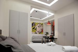 a bedroom with a bed and a living room at Apartment at Eksarhia center in Athens
