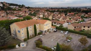 an aerial view of a large house with a parking lot at Hotel Lyon Sud, Pierre Benite, St Genis Laval in Pierre-Bénite