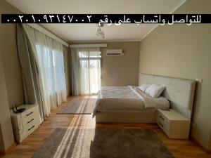 a bedroom with a bed and a large window at Villa paradise for rent in Elshikh zayed in Abū Rawwāsh