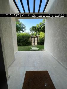 a view from the inside of a building with a gate at Villa paradise for rent in Elshikh zayed in Abū Rawwāsh