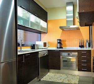 a kitchen with stainless steel appliances and brown cabinets at 1208 - EXCLUSIVE DESIGN APARTMENT in Barcelona