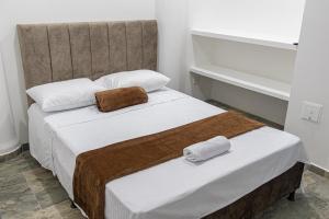 Voodi või voodid majutusasutuse Hotel Maranta toas
