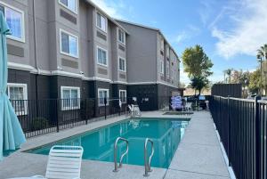 una piscina frente a un edificio de apartamentos en La Quinta by Wyndham Tulare, en Tulare