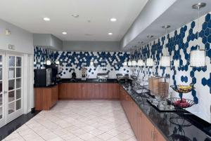a large kitchen with blue and white patterned walls at La Quinta by Wyndham Tulare in Tulare