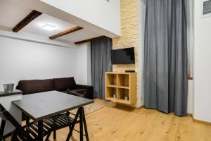 a living room with a table and a couch at Posh Prints Studio in Budapest