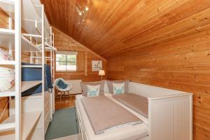 Postel nebo postele na pokoji v ubytování Ferienhaus Holzperle am Meer